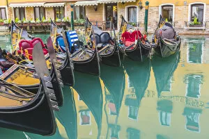 Images Dated 6th February 2018: Venice, Veneto, Italy. Colorful moored gondolas reflecting in the water