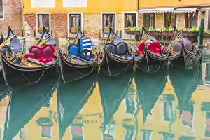 Venice Prints: Venice, Veneto, Italy. Colorful moored gondolas reflecting in the water