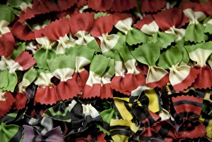 Venice, Veneto, Italy; Coloured pasta on display in a shop window Venice, Veneto, Italy; Coloured pasta on display in a shop window