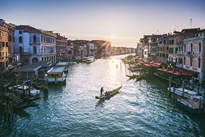 Venice, Veneto, Italy. Gondola in Grand Canal at sunset from Rialto bridge