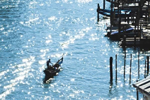 Venice, Veneto, Italy. Gondola rowing along the Canal Grande