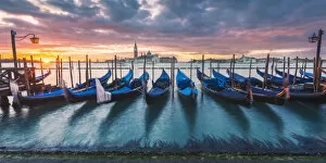 Venice, Veneto, Italy. Gondolas moored on Riva degli Schiavoni at sunrise