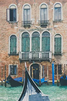 Venice, Veneto, Italy. Gondolas and waterfront palace