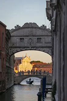 Sights Prints: Venice, Veneto, Italy. Gondolier under bridge of Sighs and St George church illuminated at sunset