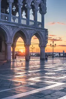 Venice, Veneto, Italy. Sunrise through the arches of Doges Palace in Piazzetta San Marco