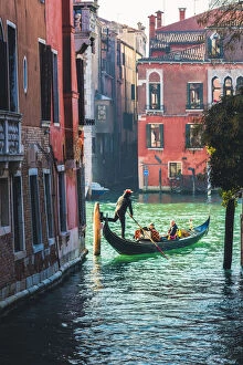 Venice Gallery: Venice, Veneto, Italy. Tourists on a gondola in a backstreet canal