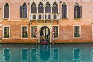Venice, Veneto, Italy. Tourists on the pier of a Waterfront palace hotel