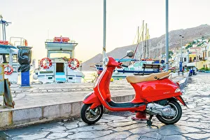 Images Dated 10th January 2023: A vespa scooter by the colourful harbour in Symi, Dodecanese Islands, Greece