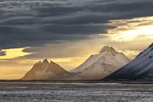 The Vestrahorn mountain illuminated by a war sun ray during a winter sunset, Austurland, Southern Iceland