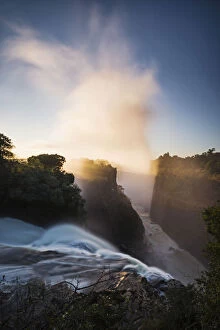 Zambesi Gallery: The Victoria Falls depicted at sunrise from Devils Cataract, in Zimbabwe side
