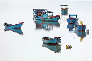Images Dated 7th February 2023: Vietnam, Cam Ranh, traditional fishing boats reflected in calm water
