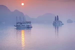 Images Dated 16th February 2015: Vietnam, Halong Bay, tourist boats, sunrise