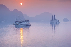 Images Dated 16th February 2015: Vietnam, Halong Bay, tourist boats, sunrise