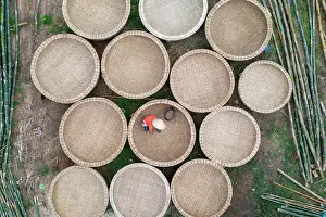 Craft Prints: Vietnam, Phu Yen Province, a woman works in a basket boat factory
