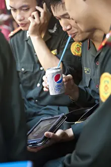 Products Prints: Vietnamese Soldiers enjoying modern Western products, Hanoi, Vietnam