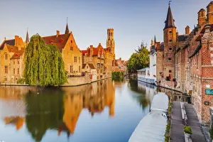View of Bruges old town reflecting in the water canal at sunrise, Belgium