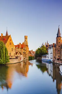 View of Bruges old town reflecting in the water canal at sunrise, Belgium