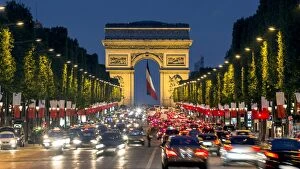 Paris Gallery: View down the Champs Elysees to the Arc de Triomphe, illuminated at dusk, Paris, France