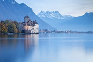 View of the Chillon castle on Lake Geneva and Dents du Midi at sunset. Veytaux, Montreux