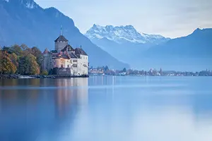 View of the Chillon castle on Lake Geneva and Dents du Midi at sunset. Veytaux, Montreux