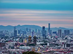 View over the city towards the cathedral and high rise buildings at sunset, City of Puebla, Puebla State, Mexico