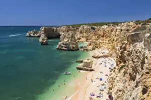 Top view of cliffs and turquoise water of the ocean Praia da Marinha Caramujeira Lagoa