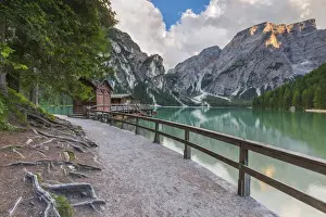 Bozen Prints: A view of Croda del Becco and footpath and house of boats from Braies lake at sunset