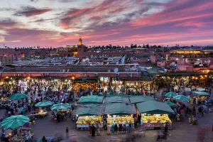 Market Place Prints: View over Djemaa el-Fna square and market place toward Koutoubia Mosque at dusk