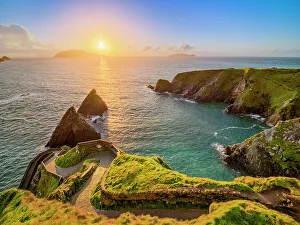 Loneliness Prints: View over Dunquin Pier towards Blasket Islands at sunset