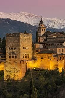 Royal Palace Collection: View at dusk of Alhambra palace with the snowy Sierra Nevada in the background, Granada