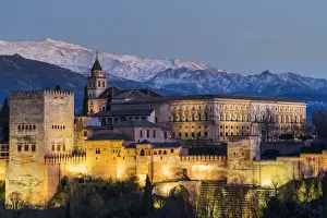 View at dusk of Alhambra palace with the snowy Sierra Nevada in the background, Granada