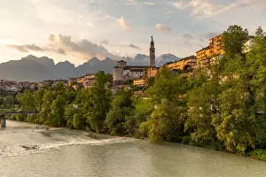 Tower Bell Prints: View of the historic center of Belluno with the Piave river flowing at sunset