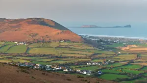 View from Llanmadoc Hill over the village of Llangennith towards Rhossili Bay and Worm's Head, Gower Peninsula, South Wales, UK. Spring (March) 2022