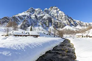 Valle Antigorio Prints: View of mountain huts near the torrent Devero in the small town of Crampiolo in winter