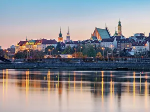 View over River Vistula towards The Old Town and Royal Castle at dusk, Warsaw, Masovian Voivodeship, Poland