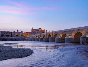 Guadalquivir River Prints: View over Roman Bridge of Cordoba and Guadalquivir River towards the Mosque Cathedral
