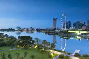 View of Singapore Flyer, Marina Bay Sands Hotel and Gardens by the Bay at dawn, Singapore