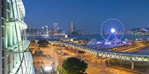 View of Star Ferry pier, observation wheel and Tsim Sha Tsui skyline, Hong Kong, China
