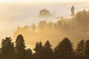 Lake Maggiore Collection: View of the Statue of San Carlo Borromeo in the morning winter fogs