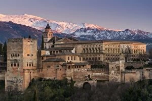View at sunset of Alhambra palace with the snowy Sierra Nevada in the background