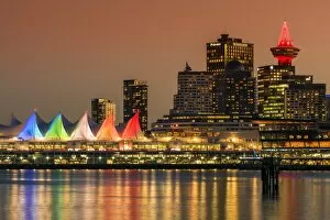 View at sunset of Canada Place and Harbour Centre building decorated with Christmas lights