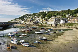 October Prints: Views over Mousehole village and harbour at low tide on a sunny day