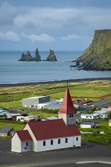 Basalt Rock Prints: Vik i Mydral Church in Vik with Reynisdrangar rock formation in background, Vik i Mydral