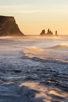 Vik, Southern Iceland, Europe. The rock formations of Reynisdrangar and ocean waves