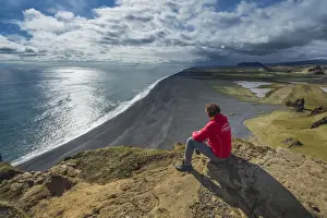 Reynisdrangar Prints: Vik, Southern Iceland. Man looks the horizon on top of Dyrholaey