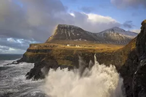 Wind Gallery: The village of Gasadalur and its waterfal hit by a storm. Island of Vagar. Faroe Islands