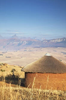 Village hut with Cathedral Peak in background, Ukhahlamba-Drakensberg Park, KwaZulu-Natal