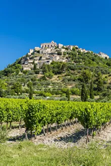 Images Dated 4th August 2015: Vineyards with village of Gordes in the background, Vaucluse, Provence, France