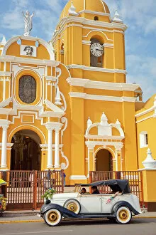 Plaza De Armas Gallery: A vintage car in front of the Cathedral Basilica of St. Mary in the 'Plaza de Armas'of Trujillo