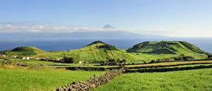 Volcanic craters along the Sao Jorge island and the Pico volcano on the horizon
